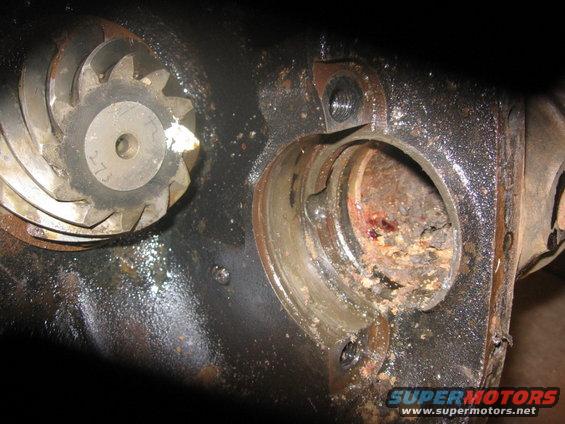 Close-up of a differential gear and rusty housing. Some numbers are visible on the gear