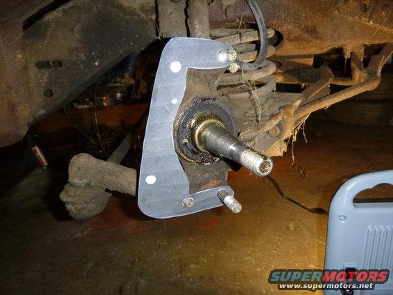 close-up of a vehicle's wheel hub and suspension components with a new gasket installed