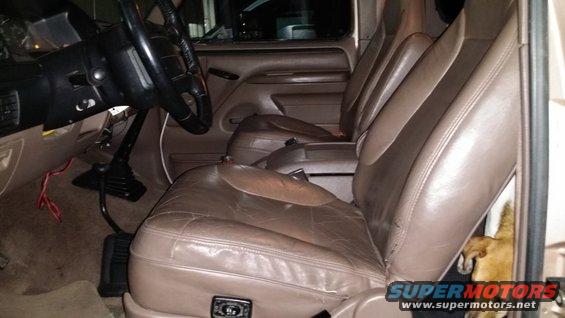 1990s truck interior with leather seats, steering wheel, and floor shifter