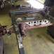 1994 Ford Bronco - Close-up view of a vehicle's frame and axle components, suspended by chains.