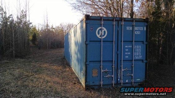 cntnr07.jpg The weather has been reasonably dry for a few days now, so I called a container company & ordered a 40' single-end.  It's now tucked out of sight, but where my neighbors can see the doors.  My next investments will be padlocks, and a ladder to attach to the inside of the door.