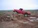 1976 Ford F-100 - 1976 Ford F-100 navigating a rocky obstacle during an off-road excursion.