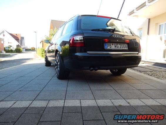 Black 2003 Audi A6 wagon parked on a paved driveway, rear view