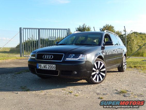 Dark gray Audi A6 Avant wagon with custom wheels parked outdoors