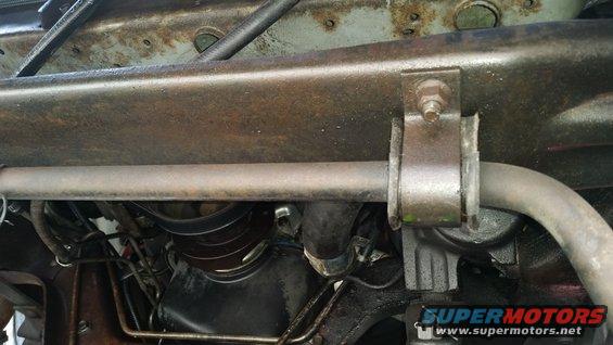 Underside view of a truck frame with suspension components and engine parts visible. Watermark says SuperMotors.net