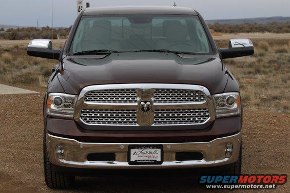 Maroon Dodge Ram pickup truck front view, chrome grille, chrome bumper, license plate frame