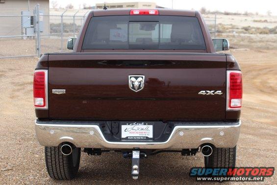 Brown Dodge Ram pickup truck rear view, chrome bumper, dual exhaust, 4x4 badge, "Laramie" badge