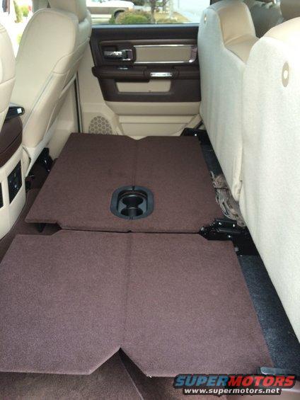 Interior rear floor with folded seats and cup holder