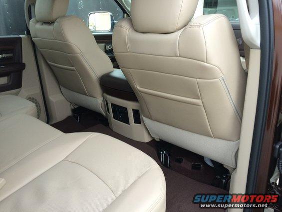 Interior view of rear seats in a 2015 Dodge 1500, showing beige leather upholstery and center console