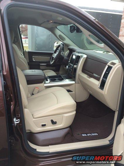 Interior of a brown Ram truck, showing tan leather seats, dashboard, and center console