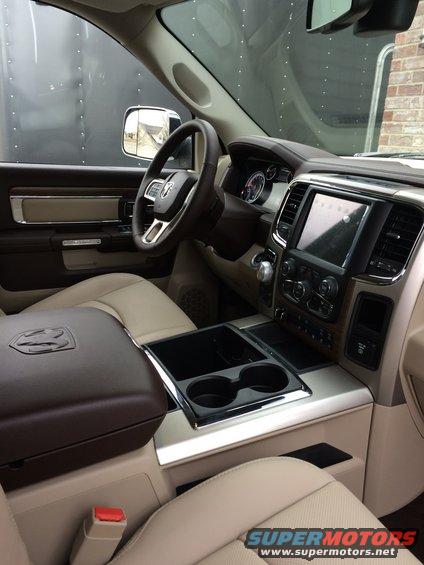 Tan and brown interior of a 2015 Dodge 1500 truck, showing the dashboard, steering wheel, and center console