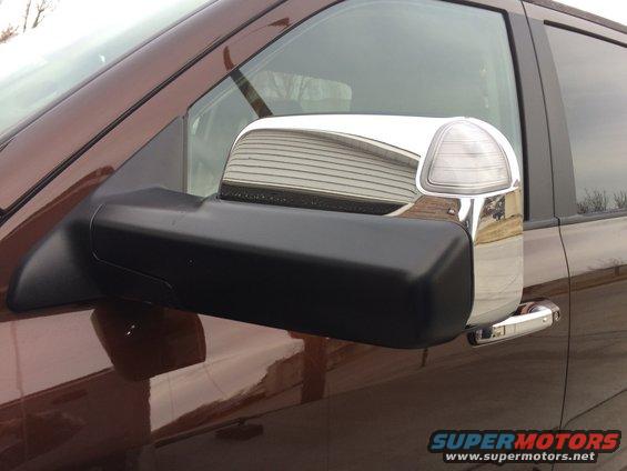 Truck's side mirror with chrome trim and turn signal indicator