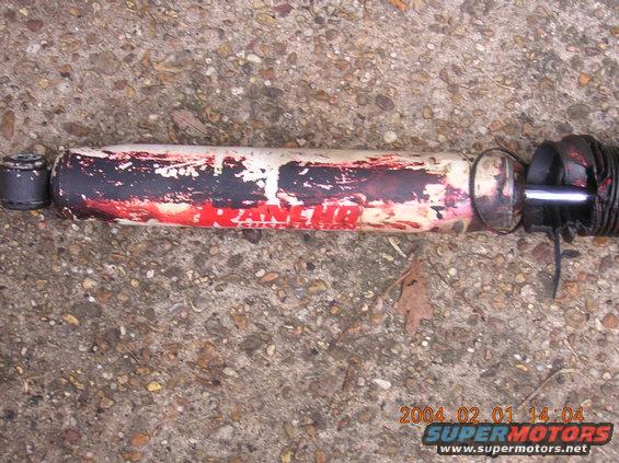 Rancho shock absorber with red and white paint, some rust. Date stamp 2004