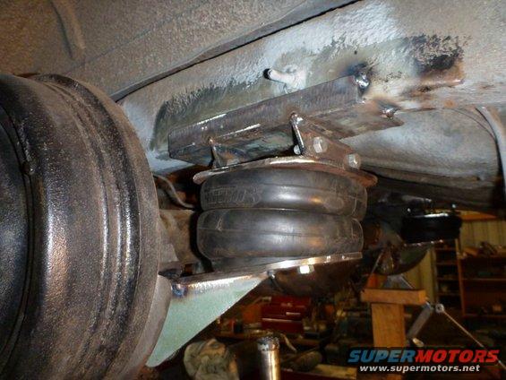 Air suspension bellows and mounting hardware under vehicle