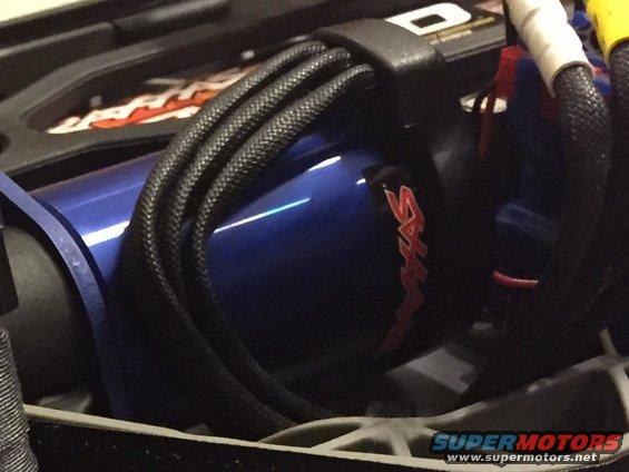 Close-up of blue motor with red 'Traxxas' logo and black wiring harness