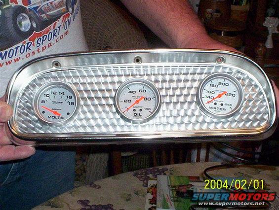 Chrome gauge cluster with three dials: volts, oil, and water temperature