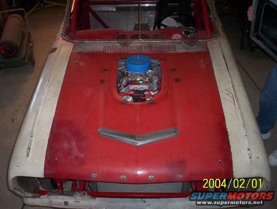1963 Ford Falcon front view, red hood with exposed engine, white fenders