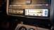 1993 Mercury Tracer - Aftermarket audio components installed in a vehicle's dashboard, including a CD player and an amplifier controller.