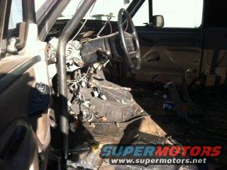 Interior of a vehicle with dashboard removed and wiring exposed
