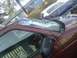 2000 Chevrolet Astro - The front of a maroon van is shown with a severely damaged windshield and a dark side mirror.