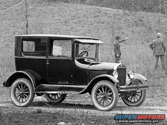 Black sedan with two men standing nearby, one pointing