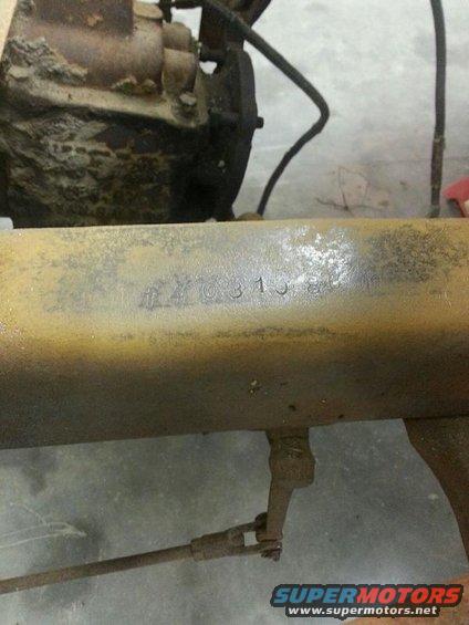 Rusty metal beam with stamped numbers 'XY031584'