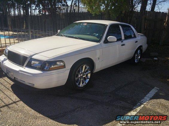 White 2000 Mercury Grand Marquis parked on asphalt, front 3/4 view