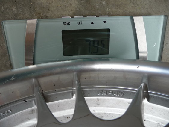 Wheel weighing 79.5 on a digital scale, marked 'JAPAN'