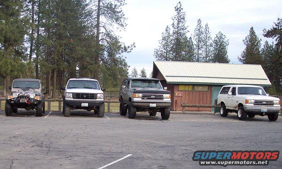 Gray 1992 Ford Bronco parked in a lot with other vehicles and a building
