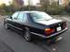 1988 BMW 7 Series - This 1988 BMW 7 Series sedan is seen from the rear 3/4 angle, showing its distinctive taillights and badging.