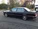 1988 BMW 7 Series - Side view of a black 1988 BMW 7 Series sedan.