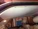 1988 BMW 7 Series - Interior view of a car, focusing on the headliner and seats, with a glimpse of the outside.