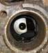 1995 Ford Bronco - A close-up view of an engine part, showing oil and debris within its housing.