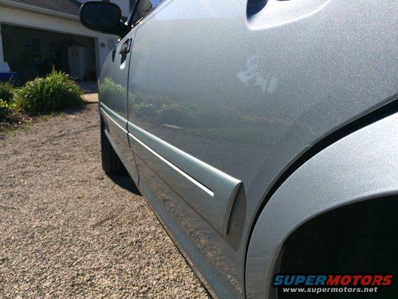 Silver 2003 Ford Crown Victoria side door and fender detail
