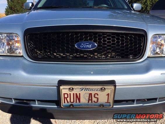 Light blue 2003 Ford Crown Victoria front grille with Ford logo and Illinois license plate 'RUN AS 1'