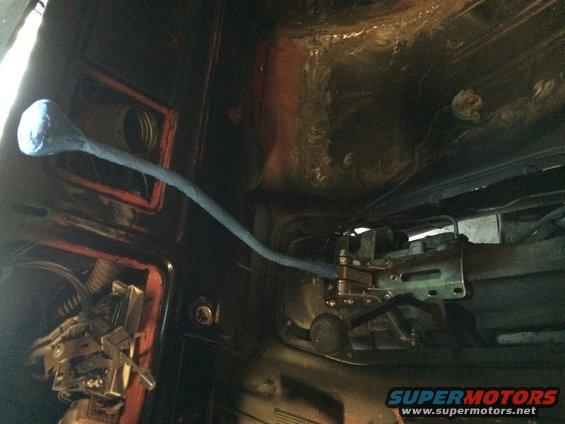 Transmission shifter linkage and housing inside a vehicle
