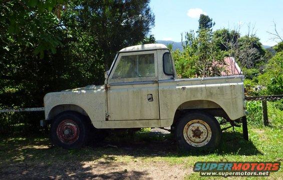 Side view of a weathered cream-colored pickup truck with a single cab and bed