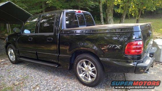 Black 2003 Ford F-150 GTX pickup truck, rear 3/4 view