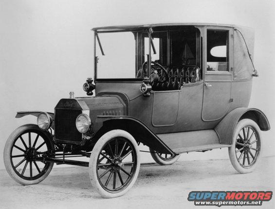 1915 Ford Model T touring car, black and white, 3/4 front view, with a soft top and whitewall tires