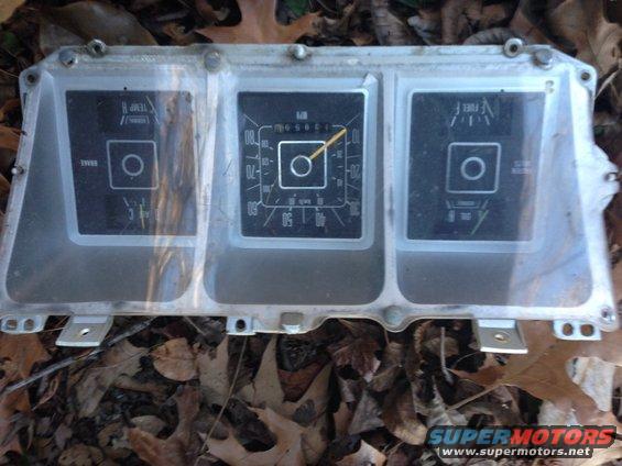 Vehicle dashboard gauge cluster with speedometer, fuel, and temperature gauges
