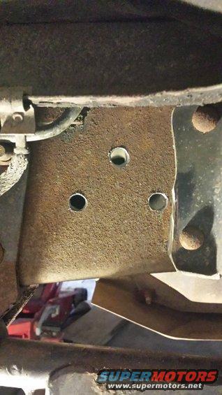 20150215_154906.jpg Holes drilled now to clean up the surface rust a bit.  I so love drilling into the frame rail.. :/

You can also see where the body mount has been cut down.