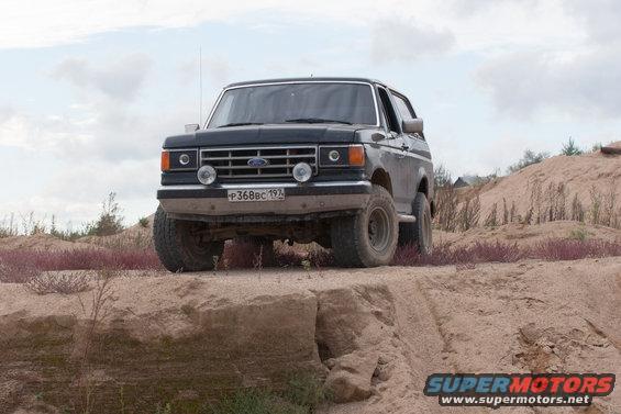 Black 1987 Ford Bronco 3q-front view on a dirt embankment