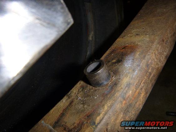 Close-up of rusty metal frame with cylindrical protrusion