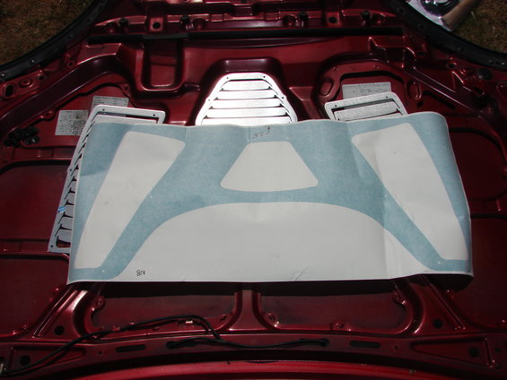 Hood vents with a large decal on a red car's underside