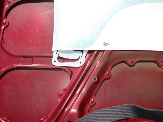 Underhood of red car with paper template showing '9N'