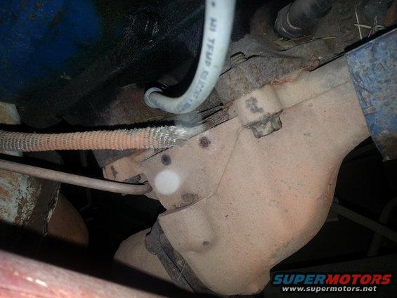Close-up of an exhaust manifold with a silicone hose and wiring harness