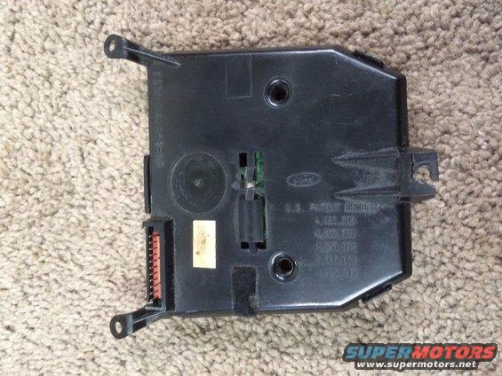Black Ford electronic control module with orange connector and patent numbers stamped on casing