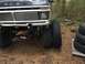 1971 Ford F-250 - Front view of a black 1973 Ford F-Series truck with a chrome grille and large tires, parked outdoors.
