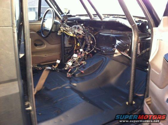 Interior of a vehicle with exposed wiring and a roll cage
