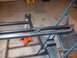 1991 Ford Bronco - A metal frame, possibly for a vehicle modification, is supported by jack stands in a garage.